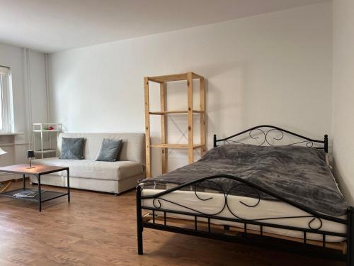 a bedroom with a bed and a couch at LuxusCityApartment in Berlin
