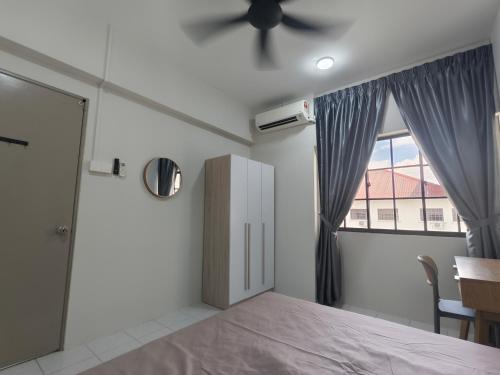 a bedroom with a bed and a ceiling fan at Petalz resident in Kuala Lumpur