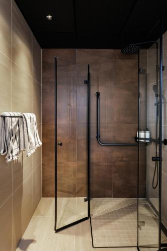 a shower with a glass door in a bathroom at Rosenlund Hamn in Sande