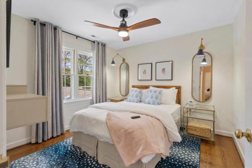 a bedroom with a bed and a ceiling fan at The Raleigh Resort House in Millbrook