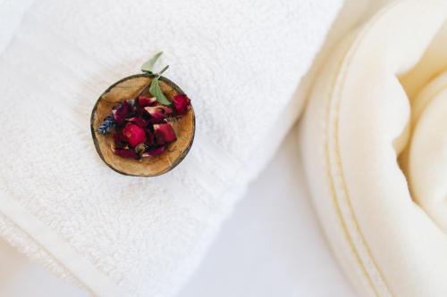 a pomegranate on a napkin on a white plate at Matar baYaar מטר ביער in El-Rom