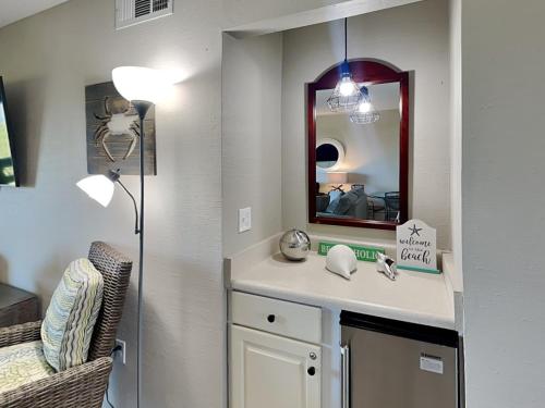 a bathroom with a sink and a mirror at Lighthouse Point by Tybee Vacation Rentals in Tybee Island