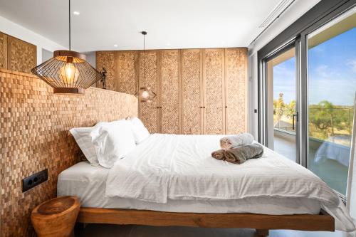 a bedroom with a bed with a teddy bear on it at Serenity Blue Luxury Villa 7 Bedrooms in Koutouloufari