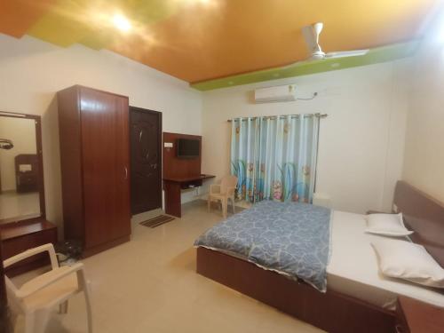a bedroom with a bed and a dresser and a mirror at SringeriRooms in Sringeri