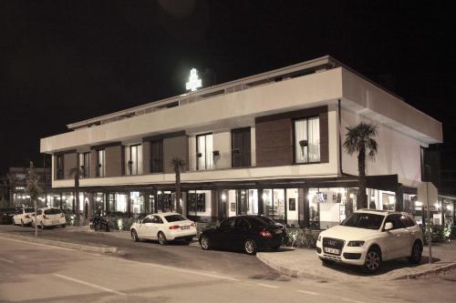 a building with cars parked in front of it at night at Casa Bianca Hotel in Denizli