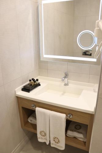 a bathroom with a sink and a mirror and towels at DES'OTEL in Tekirdağ