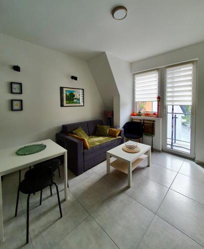 a living room with a couch and a table at Zmaj 16 in Divčibare