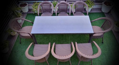 a table and chairs with a white table and a group thereof at Hotel Seven Hills Tower in Agra