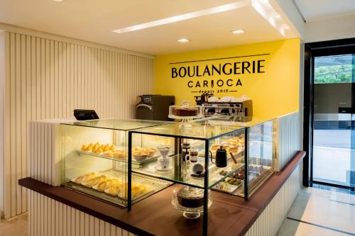a bakery with a display case filled with food at Mercure Sao Paulo Pamplona in Sao Paulo