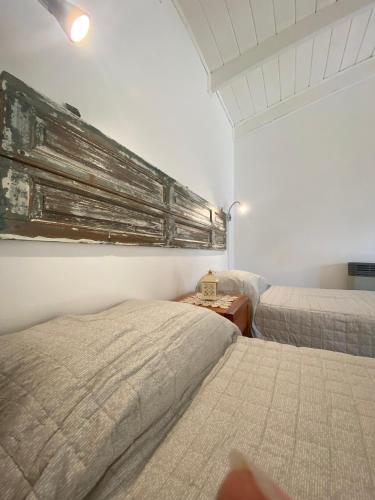 a bedroom with two beds and a table with a lamp at Inti Laufquen in San Carlos de Bariloche