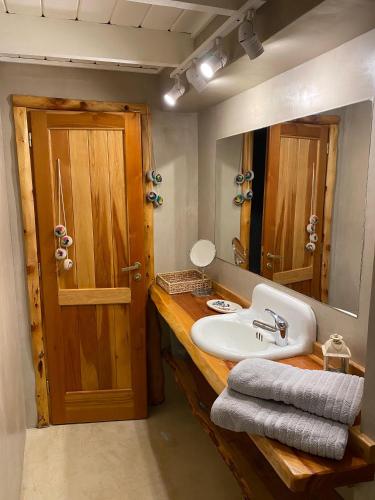 a bathroom with a sink and a mirror at Inti Laufquen in San Carlos de Bariloche