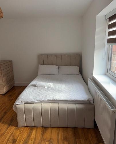 a small bedroom with a bed in a room at Large Double Room in Longbridge