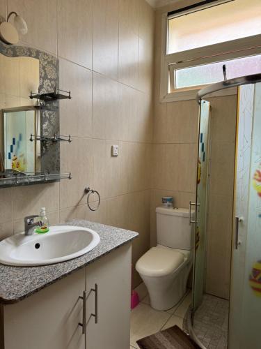 a bathroom with a sink and a toilet at Your Oasis in Kigali in Kigali