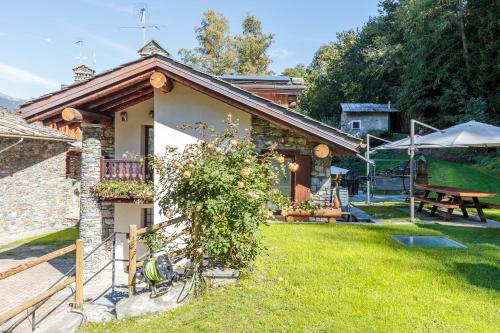 Una cabaña con jardín y mesa de picnic. en Chalet L'École, en Auri Grande