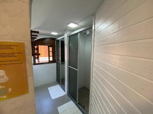 a hallway with a glass door in a building at Apartamentos Gramado Centro - Localizados Próximo a Rua Coberta in Gramado