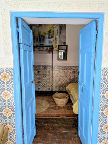 an open blue door in a room with a room at Mandalahome in Marrakesh
