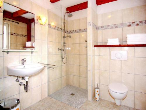 a bathroom with a shower and a toilet and a sink at Ferienpark Markgrafenheide in Markgrafenheide