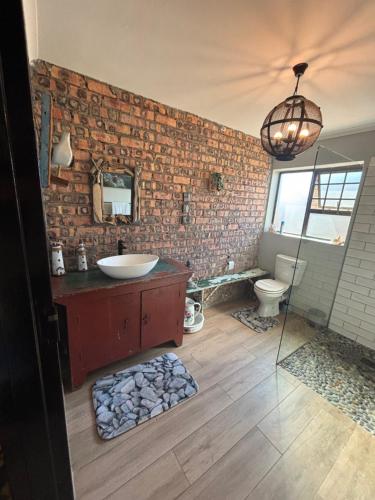 a bathroom with a sink and a mirror at Vintage Tide in Cape Town