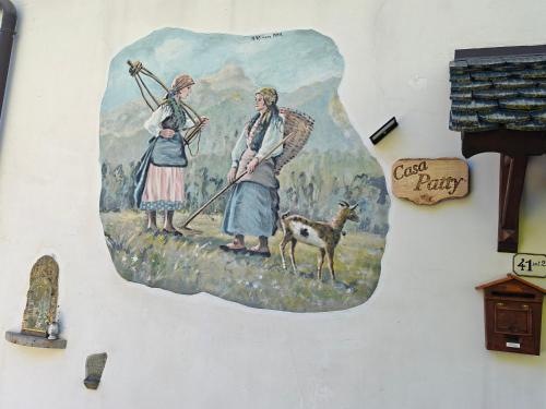 a painting of two women on a wall at Casa Patty - Liariis of Ovaro CARNIA in Ovaro
