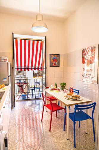 a kitchen with a table and two chairs and a table at Zietta's Pop House in Naples