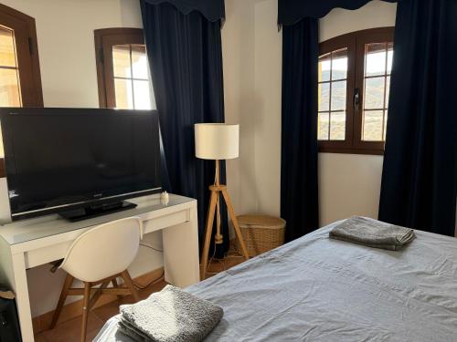 a bedroom with a flat screen tv and a bed at Luxury penthouse Apartment in Cuevas del Almanzora