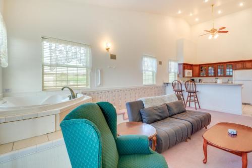 a living room with a couch and a kitchen at Ocean Shores Condo with Private Tub Less Than 1 Mi to Beach! in Ocean Shores
