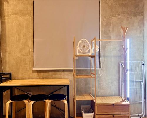 a room with two stools and a table with a fan at LoftVibes San Juan - 4 in San Juan