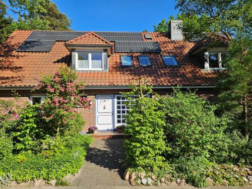a house with solar panels on the roof at Ferienwohnung Amselstieg Dr Meier in Bad Bevensen
