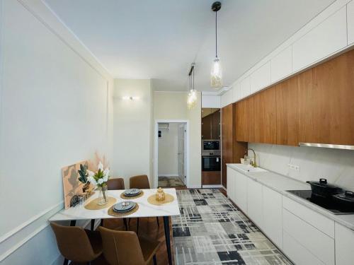 a kitchen with a table and chairs in a room at 1bdr apartment Asanbay in Bishkek