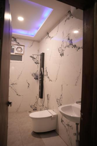 a bathroom with a toilet and a sink at Virasat Vistar Gateway in Lucknow