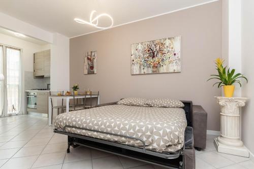 a bedroom with a bed in a room with a kitchen at Casa Mary 2 - 80 mt dal mare - centro storico in Varazze