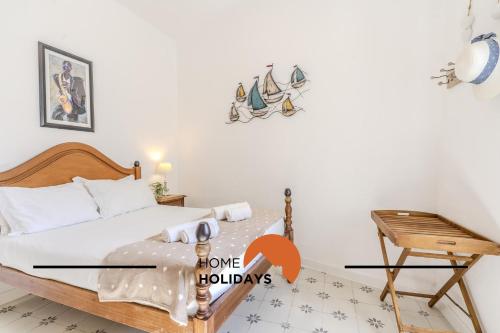 a bedroom with a bed and a desk and a table at #237 Vivenda Lilia by Home Holidays in Albufeira