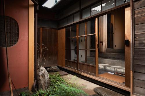 an entrance to a building with large glass doors at Tokinoma ときのま in Kawagoe