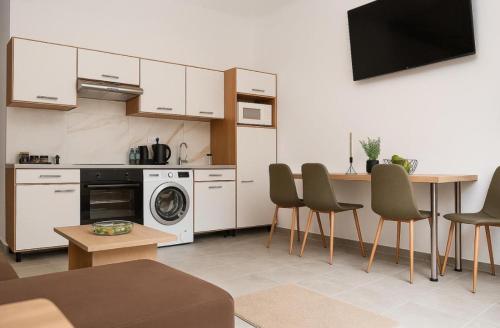 a kitchen with a table and chairs in a room at Central Nest by Summer Smile in Oradea