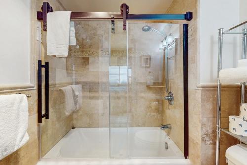 a shower with a glass door in a bathroom at Misty Morning in Sugar Mountain