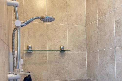 a shower with a shower head in a bathroom at 5 Bed House Sleeps 10 - 40 Minutes from Dublin in Summerhill