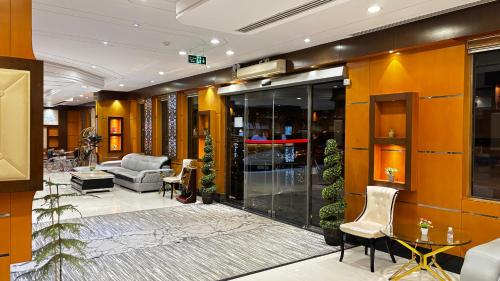 a lobby with a couch and a chair in a building at رفا للشقق المخدومة-اقتصادي in Riyadh