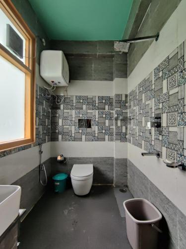 a bathroom with a toilet and a sink at Khaapus Home Naggar in Nagar