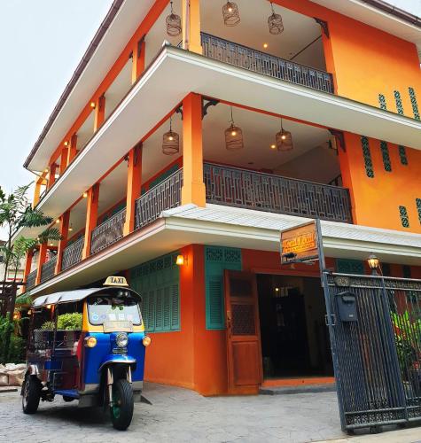 a small vehicle parked in front of a building at Focal Local Bed & Breakfast in Bangkok