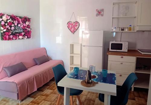 a living room with a table and a couch at Mare Sole Vento 38A Punta Prosciutto in Torre Colimena