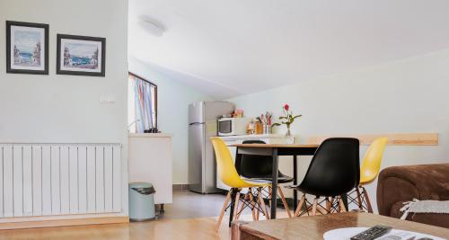 a living room with a table and yellow chairs at Green Zelina in Šulinec
