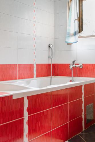 a bathroom with a sink and red tiles at Green Zelina in Šulinec