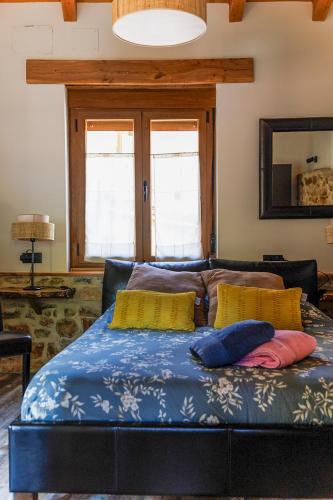 a bed with two pillows on it in a room at El Refugio II de Verdiago in Verdiago