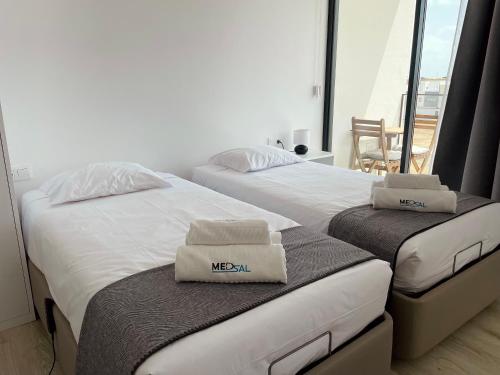 two beds sitting next to each other in a room at Medsal Residence in Prainha