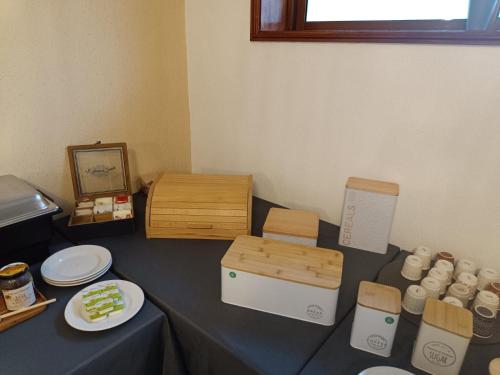 a table with plates of food and a box at SOBREIRO - Sobreiro Alojamento - Grijó in Grijó