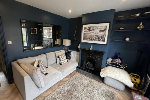 a living room with a couch and a fireplace at 3 Bed Home - Sleeps 6 Garden Pets and very central in Guildford