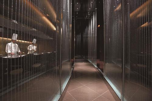 a hallway of metal cages in a building at GRAND NIKKO AWAJI in Awaji