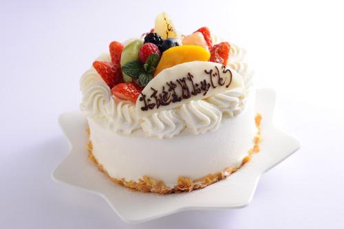 a birthday cake with fruit on top of it at GRAND NIKKO AWAJI in Awaji