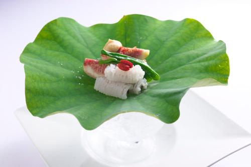 a piece of food sitting on a green leaf at GRAND NIKKO AWAJI in Awaji