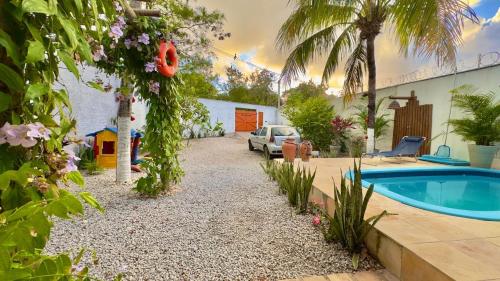 a backyard with a swimming pool and a house at CASA DA PIPA in Pipa